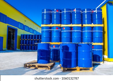 Chemical Reagents. The Blue Barrels Stand On Pallets. Chemical Industry. A Wall Of Barrels.