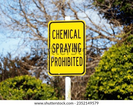 Chemical Spraying Prohibited road sign, black letters on yellow background