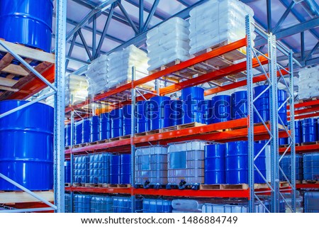 Chemical storage warehouse. Containers for chemical liquids. Warehouse system. Toxic barrels are kept in stock. Warehouse storage. Chemical Industry. Plastic barrels of chemicals are on pallets. 