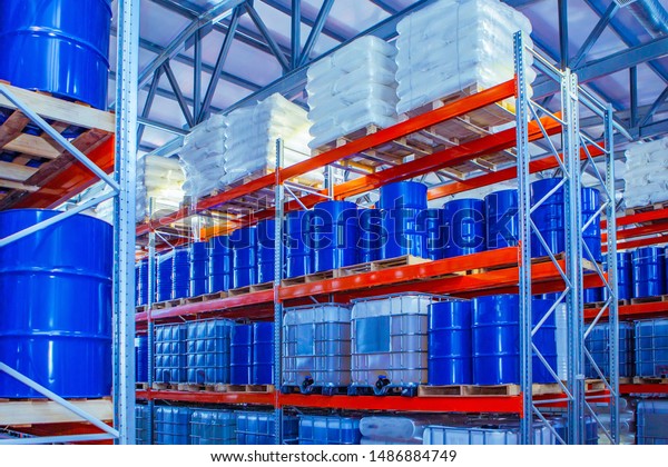 Chemical storage warehouse. Containers for chemical\
liquids. Warehouse system. Toxic barrels are kept in stock.\
Warehouse storage. Chemical Industry. Plastic barrels of chemicals\
are on pallets. 