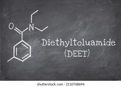 Chemical structure of diethyltoluamide (DEET), is an active ingredient in insect repellents. Blackboard background.