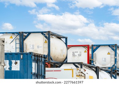Chemical tank container. ISO tank container for chemical delivery. Bulk liquid transport. Chemical company. Container freight area. Global logistics business. Chemical container for truck transport.