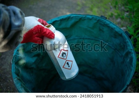 Chemically dangerous substances.A gloved hand holds a bottle of poisonous liquid.Disposal of toxic industrial waste.