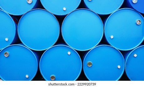 Chemicals drum, chemistry-related plastic containers, and metal-framed plastic barrels stock management in a warehouse for chemical storage. Concept of industrial manufacturing of chemicals and oil