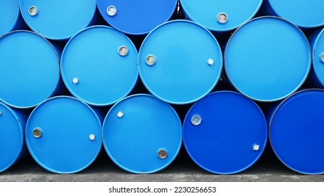 Chemicals drum, chemistry-related plastic containers, and metal-framed plastic barrels stock management in a warehouse for chemical storage. Concept of industrial manufacturing of chemicals and oil