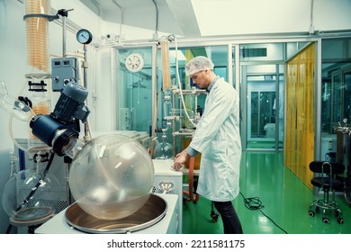 A Chemist Or Apothecary Who Extracts Cannabis, CBD Oil, And Tinctures Using Chemical Processes. Medical Cannabis Product Manufacturing Facility. Cannabis Oil Extraction Machine And Equipment.