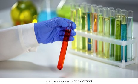 Chemist Checking Tube With Orange Liquid, Dyestuff Agent, Washing Substance