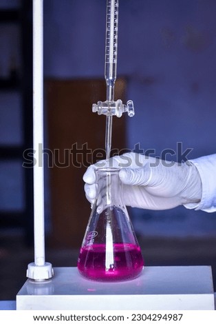 The chemist conducts acid-base titration
