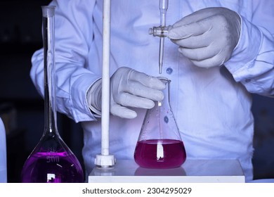 The chemist conducts acid-base titration and adding solutions