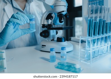 chemist is doing an experiment in the laboratory, A scientist is using a microscope to analyze the chemical composition, A scientific experiment is searching for biological answers in a laboratory,