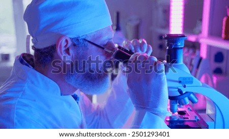 A chemist examines samples through a microscope, utilizing advanced technology in a vibrant laboratory setting.