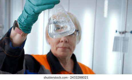Chemist holding test flask with chemical liquid. Clip. Concept of chemistry and medical science.