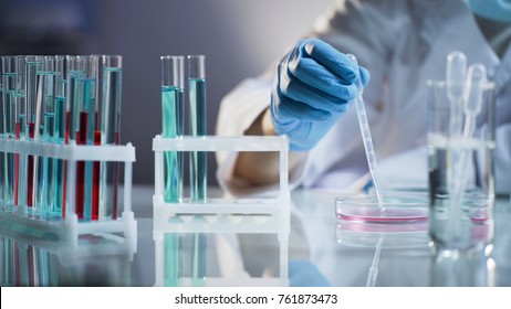 Chemist intern mixing liquids, waiting for chemical reaction at science lab - Powered by Shutterstock