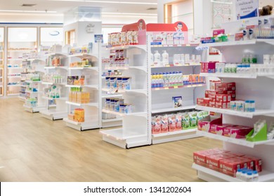 At the chemist, Medicines arranged in shelves, Pharmacy drugstore retail Interior blur abstract background with medicine healthcare product on cabinet with neon light.