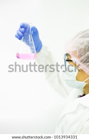 The chemist is observe the color of solution from the acid base titration method, concept of chemical laboratory in pharmaceutical industry, selective focus photograph.