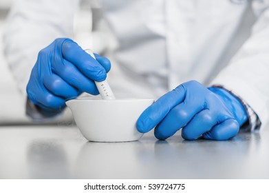 Chemist performs an experiment with liquid nitrogen in laboratory mortar with pestle - Powered by Shutterstock