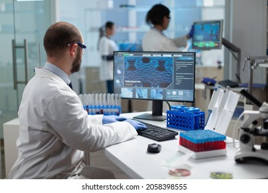 Chemist researcher doctor typing virus expertise working at coronavirus treatment during biochemistry investigation in medicine hospital laboratory. Pharmaceutics examination experiment