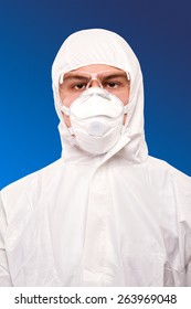 A Chemist Or A Scientist Man Wearing A Respirator, Goggles And A White Jumpsuit With A Hood 