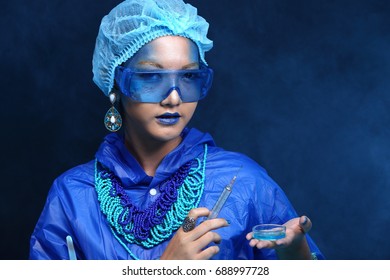 Chemistry Asian Doctor Woman With Blue Tone Fashion Make Up Fancy Lab Test Dress, Studio Lighting Black Dark Background, Safety Gear Hygiene Hat And Tube Glass