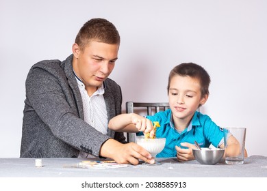 Chemistry Education And Training Concept. Close-up Of A Boy And His Dad Making A Home Experience, Making A Non-Newtonian Liquid From Starch And Water