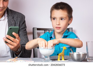 Chemistry Education And Training Concept. Close-up Of A Boy And His Dad Making A Home Experience, Making A Non-Newtonian Liquid From Starch And Water