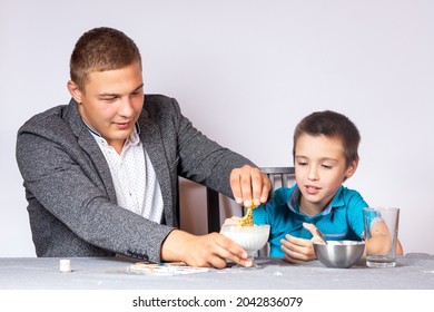 Chemistry Education And Training Concept. Close-up Of A Boy And His Dad Making A Home Experience, Making A Non-Newtonian Liquid From Starch And Water