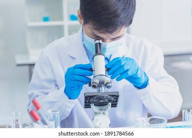 Chemistry Lab Male Students Scientist Look Into Microscope Researching Science Laboratory. Asian Student Chemistry Scientist Look Microscope Laboratory Chemistry Labs Covid-19 Coronavirus Biochemistry