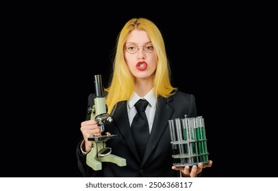 Chemistry lesson. Female student with test tubes and microscope in classroom. Science, chemistry or biology. Scientific experiment. Young teacher in university lab with test tubes and microscope - Powered by Shutterstock