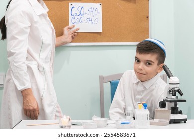 chemistry lessons, female teacher conducting chemical experiments in class with children, Jewish boy, girl with long braid, Israeli school - Powered by Shutterstock