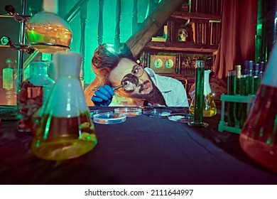 Chemistry Professor Enthusiastically Studying The Contents Of Petri Dishes In His Laboratory. Vintage Style.