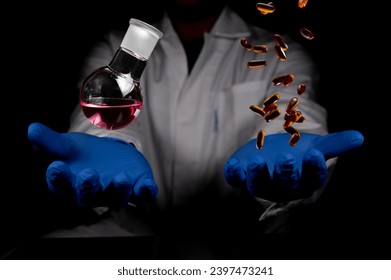Chemistry round bottom flask and transparent pills dropping on a human scientist hand with black background copy space. Medicinal chemistry red chemical solution and chemical biology.