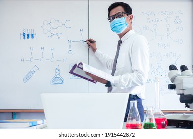 Chemistry Science Teacher Wearing Mask And   Teaching In The Classroom