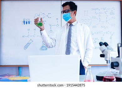 Chemistry Science Teacher Wearing Mask And   Teaching In The Classroom