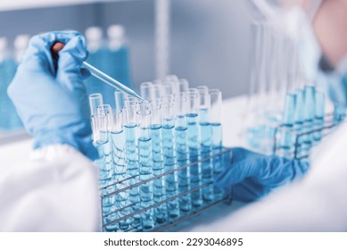 chemist,scientist hand dropping chemical liquid into test tube, science research and development concept