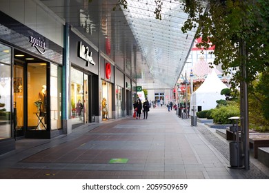 Chemnitz  Germany - 10-16-2021: View of outdoor shopping mall in Germany. Exterior of several storefronts for a shopping area. Image taken from a public access area