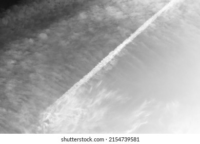 Chemtrails in a cloudy daytime sky 