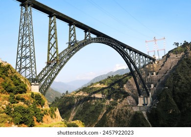 
The Chenab Bridge, also known as the Indian Railways Chenab Bridge, is a remarkable engineering marvel located in the Jammu and Kashmir region of India. It spans the Chenab River in the Reasi distric - Powered by Shutterstock