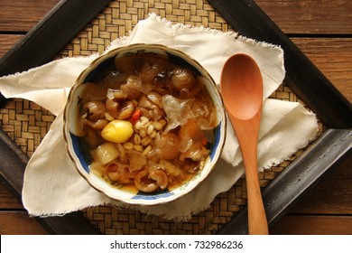 Cheng Tng. A refreshing dessert popular in Singapore. Sweet clear soup with barley, white fungus, gingko nuts, lotus seed, longan, persimmon, and wolfberry; served in ceramic bowl of vintage china.