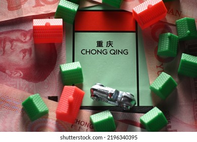 CHENGDU, CHINA - 19th Aug 2022: Chongqing City Property Field With Green Houses And Chinese Yuan Paper Notes On Monopoly Boar Game, Illustrating The Housing Market.