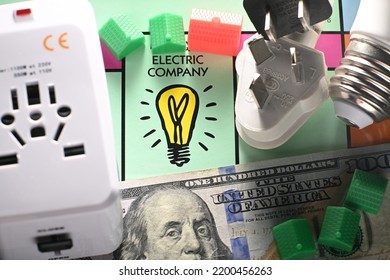 CHENGDU, CHINA - 19th Aug 2022: Electric Company Field In Monopoly Game With Dollar Banknotes, Light Bulb, AC Socket And Power Plugs Representing Utility Fees.