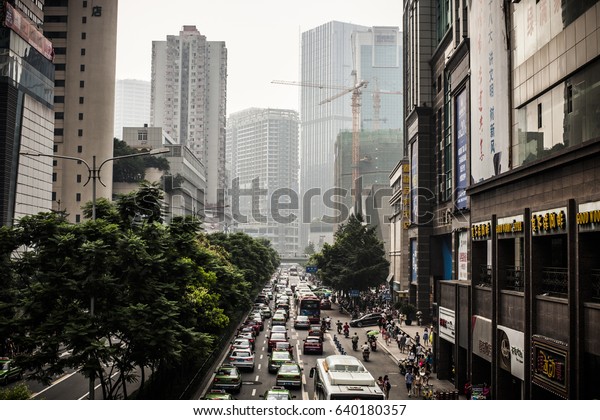 Chengdu, China - 20 July,\
2013: Chunxi Road in downtown Chengdu with rush hour traffic in the\
afternoon