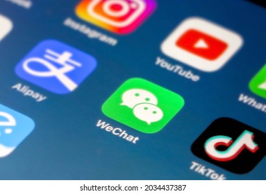 Chengdu, China - 22nd August 2021: WeChat Application Icon In Focus On IPhone Smartphone Screen, Other Apps (Tik Tok, Alipay, Instagram Etc) Out Of Focus On Blue Gradient Background Wallpaper