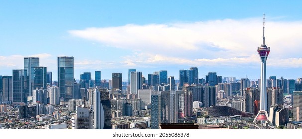 Chengdu City Panoramic Skyline, the Jinxiu Tianfu Tower (Television Tower) on the right, International Finance Square (IFS) buildings stand tall on the left, white clouds and blue sky above metropolis