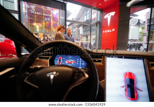 Chengdu,\
Sichuan / China - March 02 2019: Chinese consumers testing Tesla\
car in the local shopping mall Teslashowroom. Tesla has become the\
most popular car brand amid US China trade war.\
