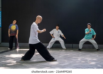 Chengdu,Sichuan,China-June 6, 2002: Elderly People Exercise In A Downtown Park.