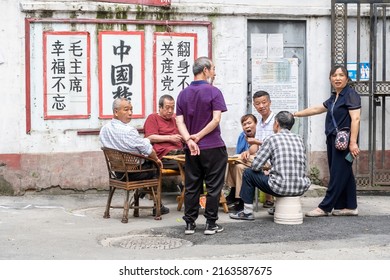 Chengdu,Sichuan,China-May 31, 2022: Several Elderly People Play Poker In An Old Residential Area, With Slogans Such As 