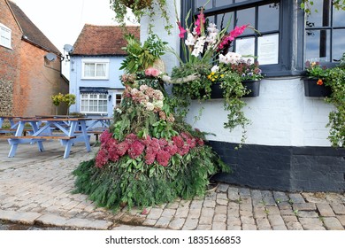 Chenies, Buckinghamshire, England, UK - October 10th 2020: Scarecrow Entitled Thank Goodness For Flowers, Outside Country Pub.