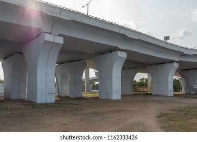 Chennai India July 29 2018 National Highway (known As Kathipaara Junction Near Guindy) Seen Flyover Pillars In Line With Sunlight Flare.dark Clouds In The Sky.