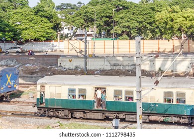 Chennai India May 27 2018 People Seen Travelling In Local Electric Train Towards Marina Beach Station. Location Is Guindy Railway Station. People Seen Footboarding In The Train Which Is Risky At Times