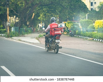 Chennai, Tamil Nadu, India - September 27, 2020: A Zomato Delivery Man Riding A Bike To Deliver Food From A Restaurant With An Isothermal Food Case.